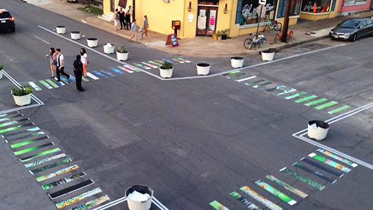 High-viz crosswalks and curb extensions using paint and potted plants (Urban Repair Squad) 
