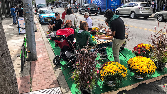 Public seating in Jersey City, NJ wooden pallets and potted plants (Street Plans) 